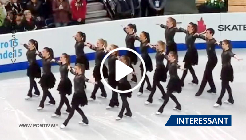 Sechszehn Eisläufer stehen in einer Linie – als die Musik beginnt machen sie etwas Außergewöhnliches	